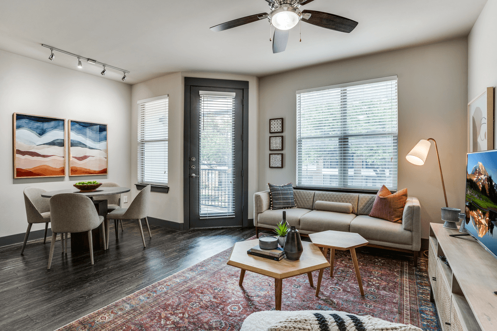 A living room with a couch, chairs, and a coffee table.