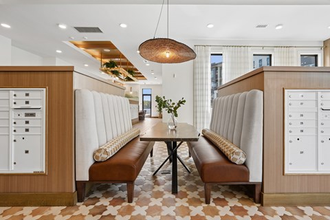 A modern dining room with a checkered floor and a wooden table.