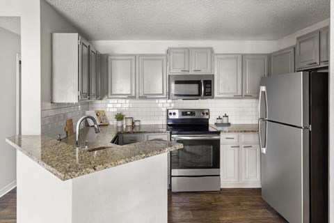 a kitchen with stainless steel appliances and a granite counter top