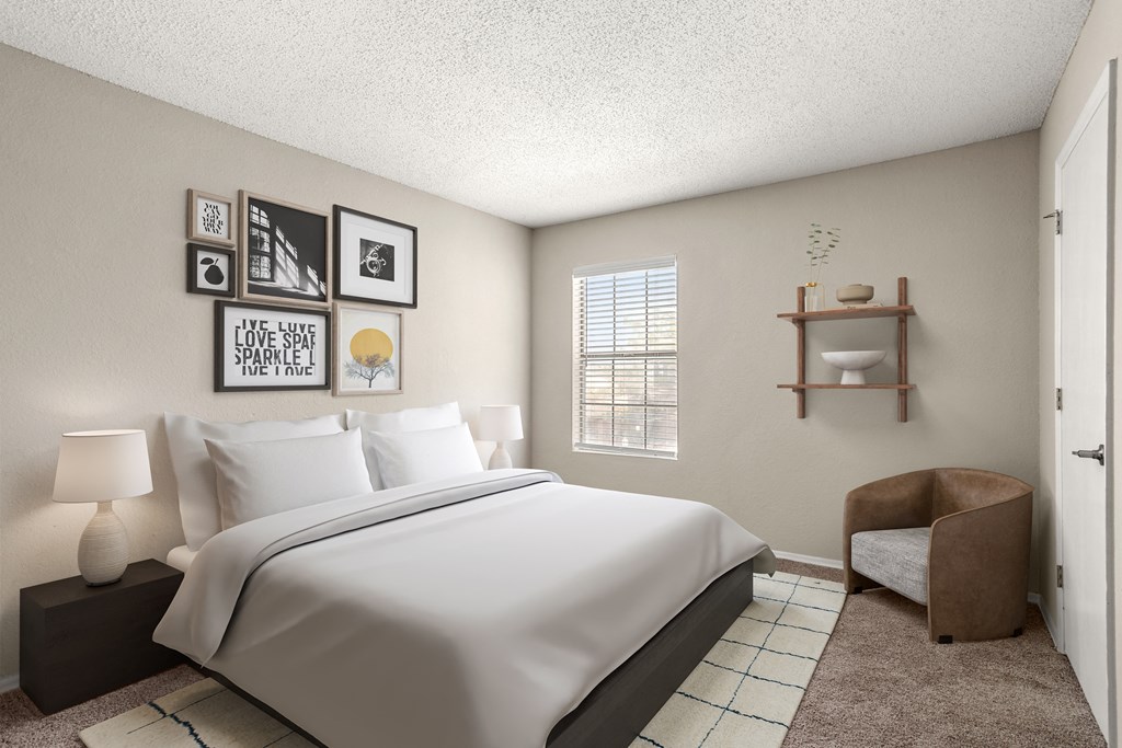 a bedroom with a bed and a chair and a window