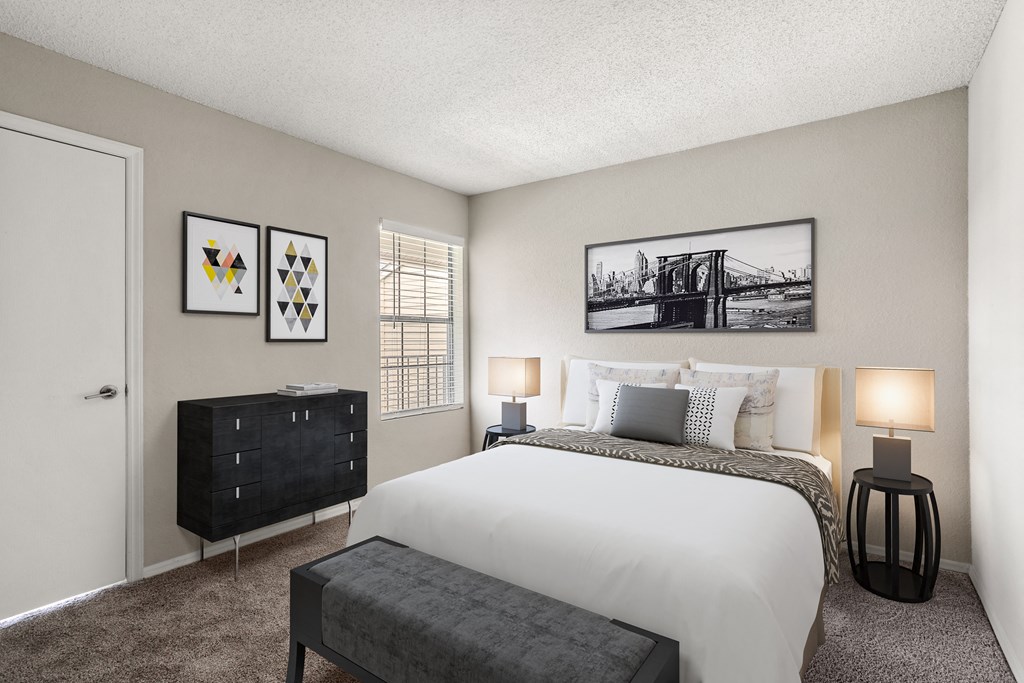 a bedroom with a bed and a dresser and a window