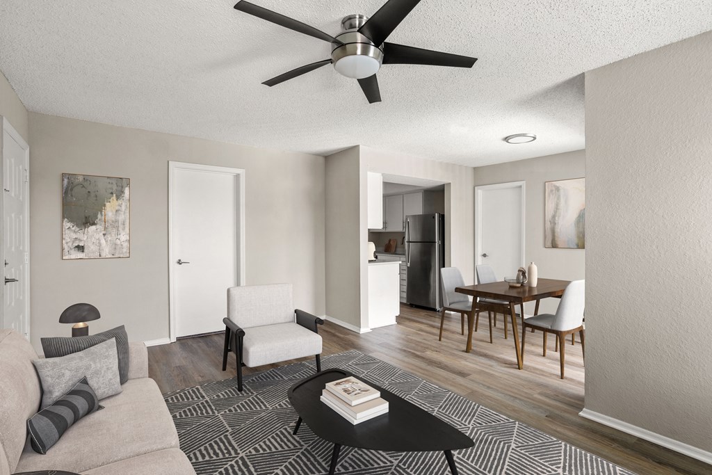 an open living room and dining room with a ceiling fan