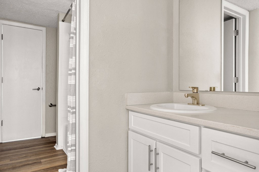 the bathroom of our studio apartment atrium with a sink and mirror