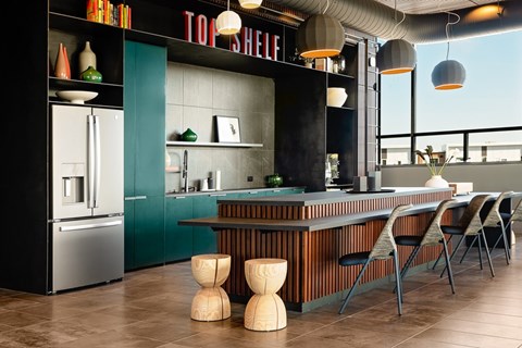 A modern kitchen with a wooden table and chairs.