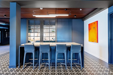 A dining room with a table and chairs.