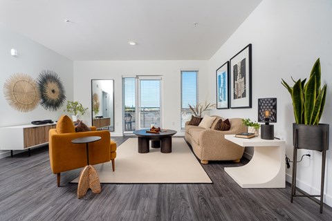 A living room with a yellow chair and a white table.