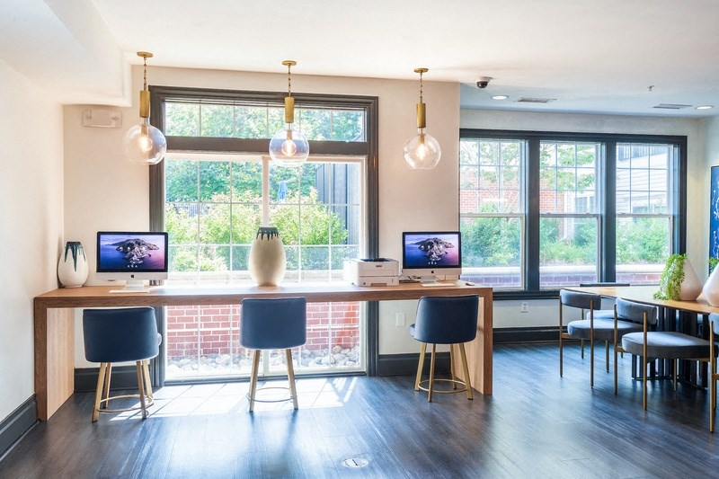 a dining room with a table and chairs and a large window