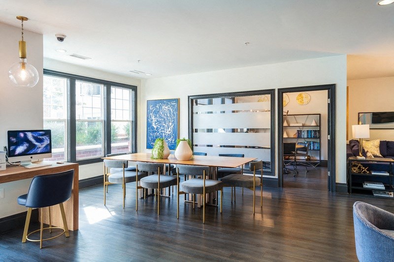 a living room with a table and chairs and a tv
