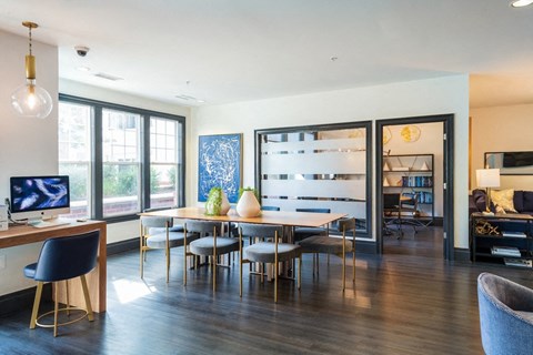 a living room with a table and chairs and a tv