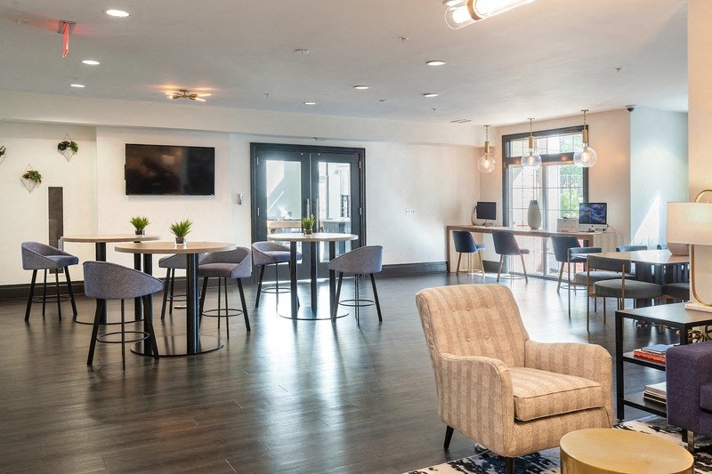 a large room with tables and chairs and a television in the corner