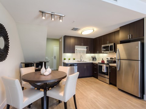 A modern kitchen with a table and chairs.