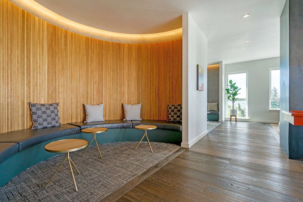 a living room with a blue couch and a wooden wall