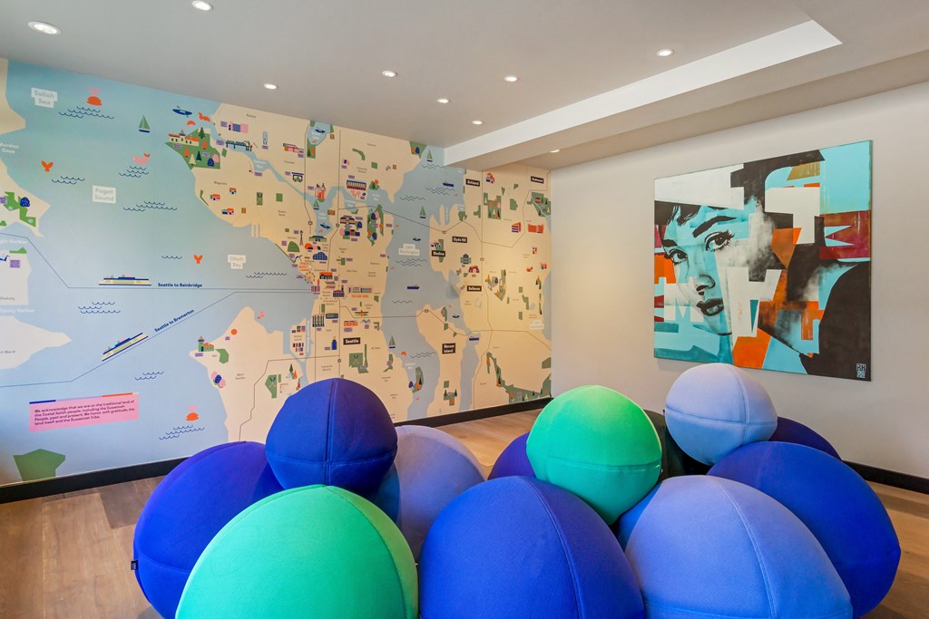 a room filled with balloons and a map of the world on the wall