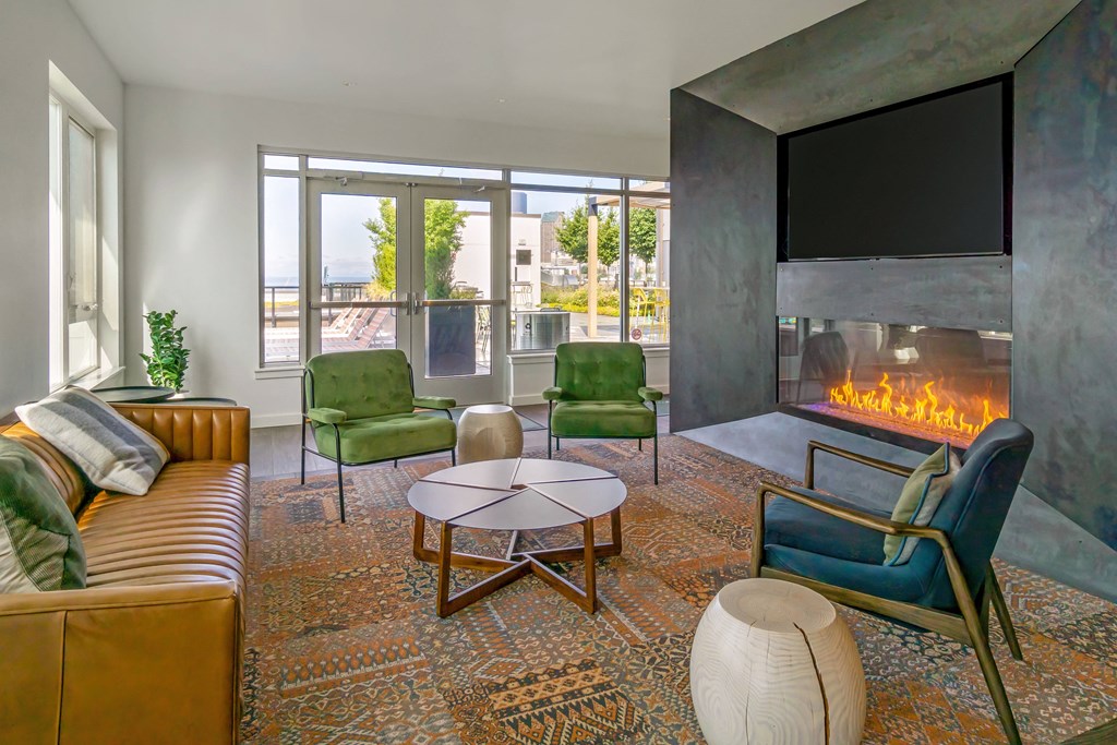 a living room with a fireplace and a couch and chairs