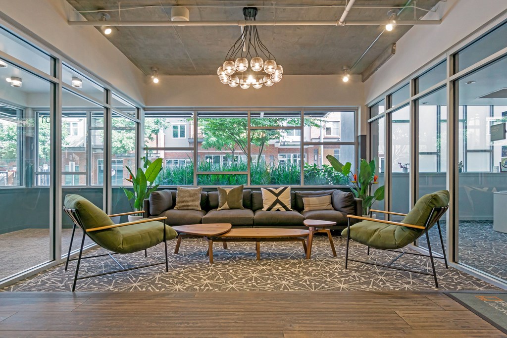 a living room with a couch and chairs in front of a window