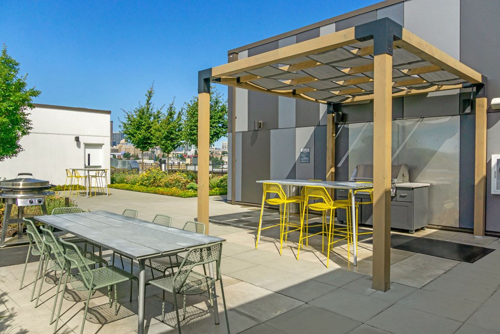 a patio with tables and chairs and a pergola