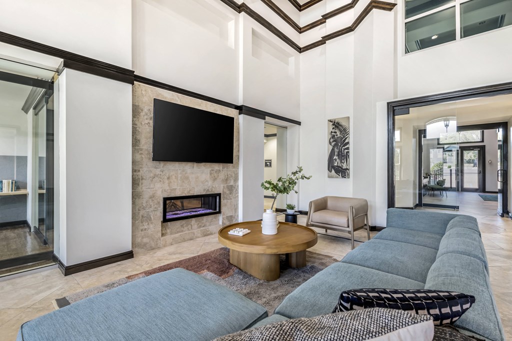 a living room filled with furniture and a flat screen tv
