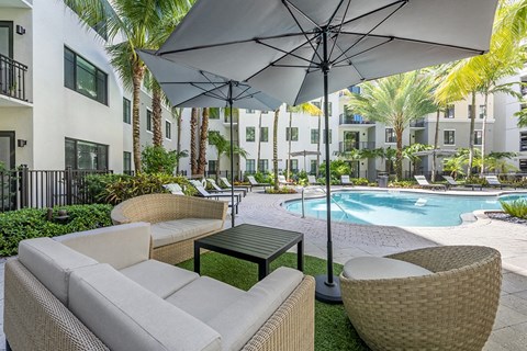 A patio with a table and chairs under an umbrella.