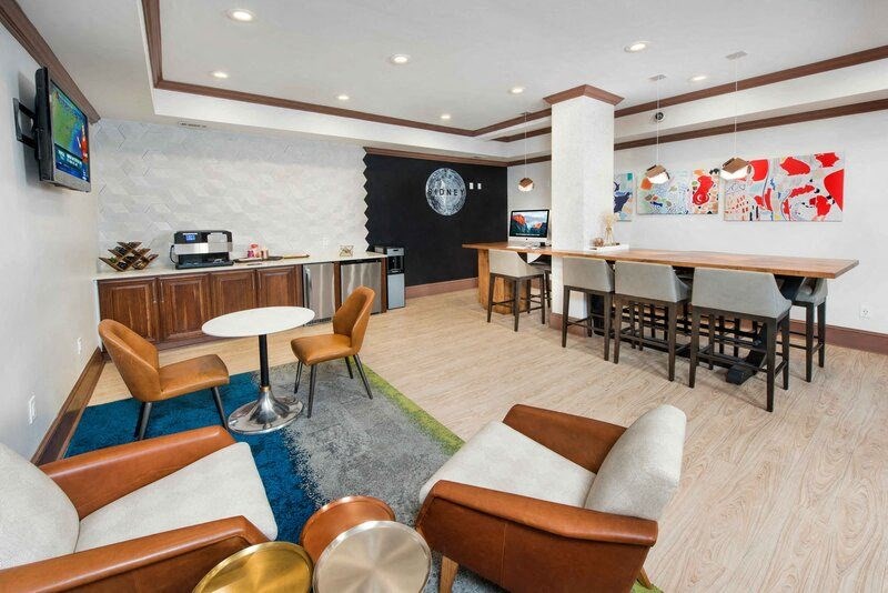 A room with a white brick wall and a black circular object on the wall.