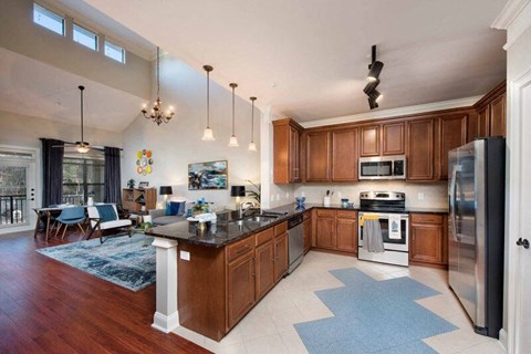a large kitchen with wooden cabinets and stainless steel appliances