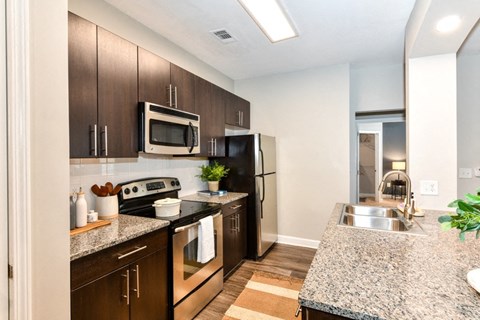 a modern kitchen with stainless steel appliances and granite counter tops