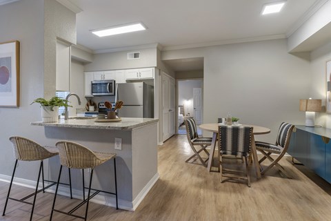 a kitchen and dining area with a table and chairs