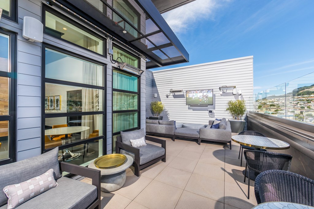 Exterior Roof Top with seating, tvs, and mountian views