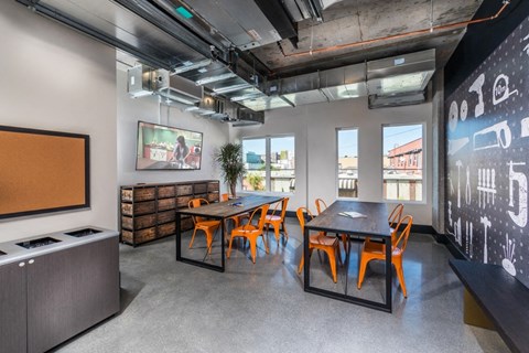 a dining room with a table and chairs and a tv