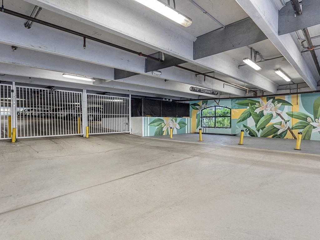 an empty parking garage with a mural on the wall