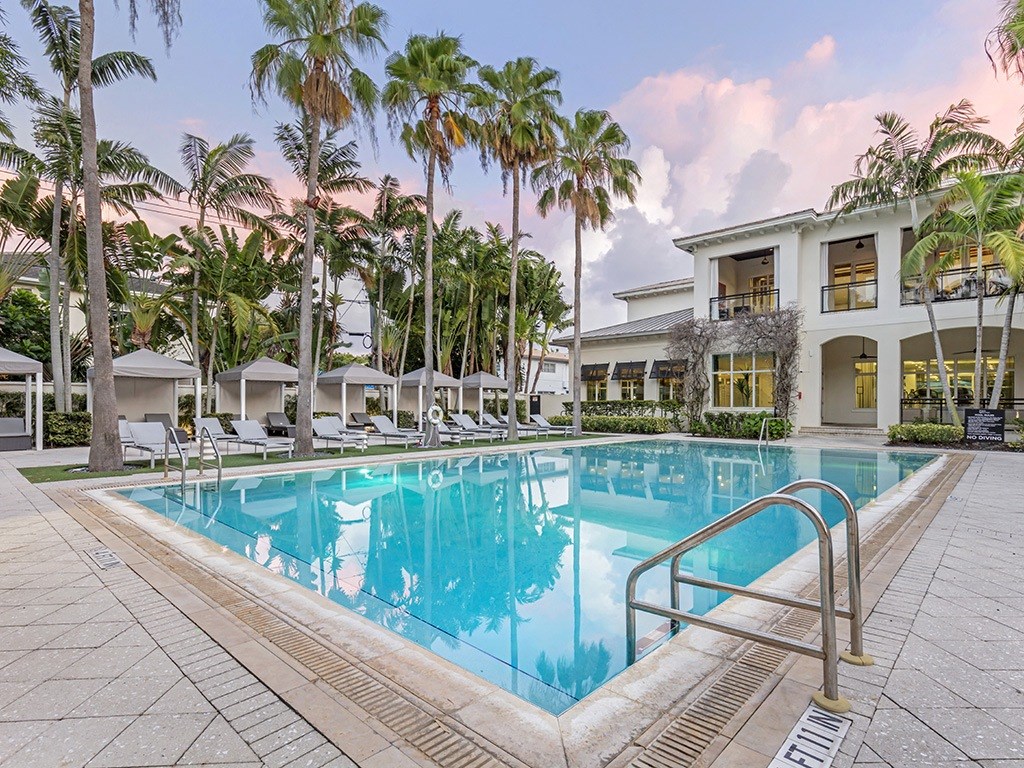 a swimming pool at a resort with palm trees