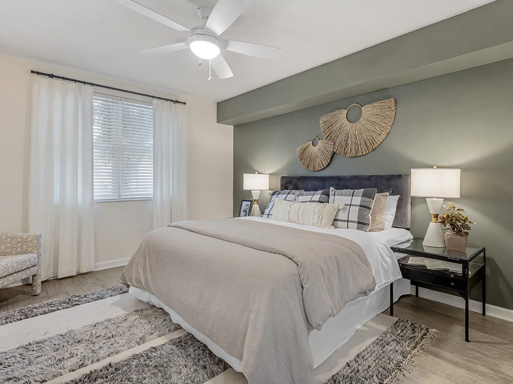 a bedroom with a bed and a ceiling fan