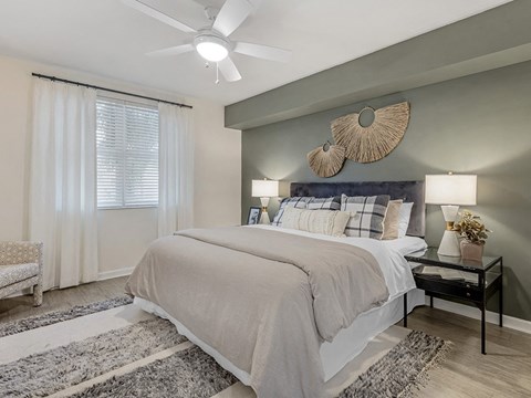 a bedroom with a bed and a ceiling fan