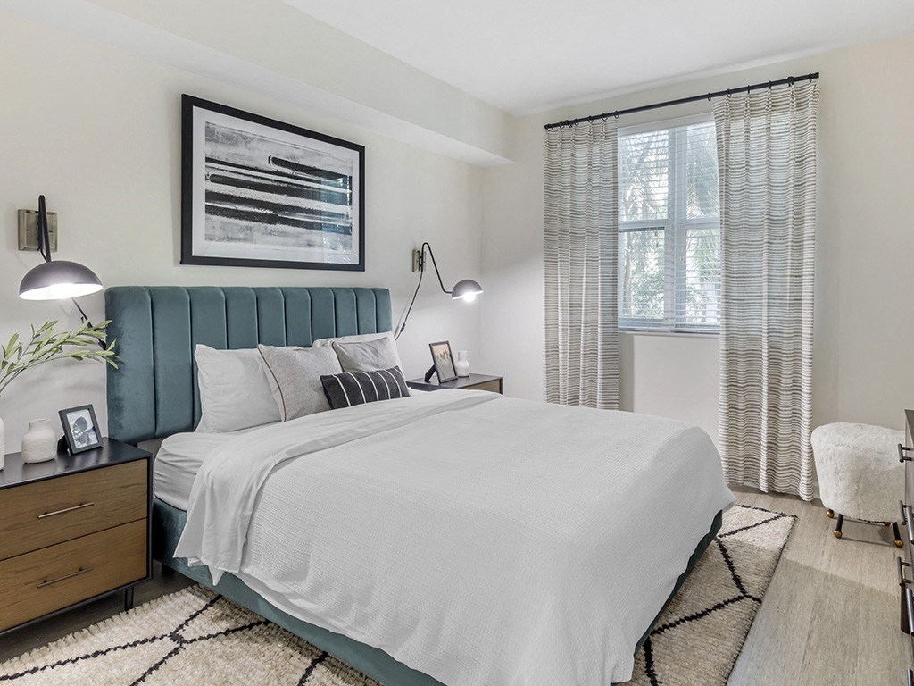 a bedroom with a large bed and a window