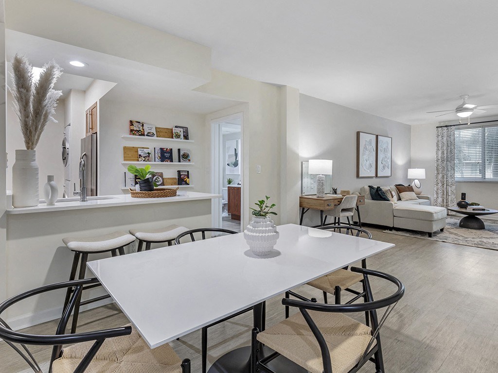 an open living room and dining room with a white table and chairs
