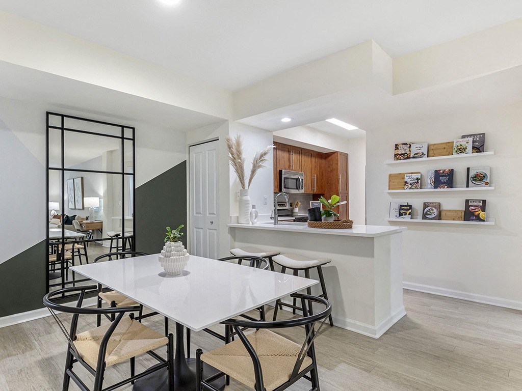 a dining room with a white table and chairs