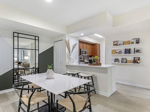 a dining room with a white table and chairs