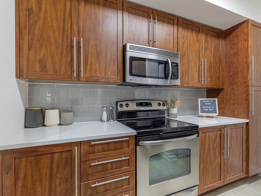 a kitchen with a stove microwave and cabinets