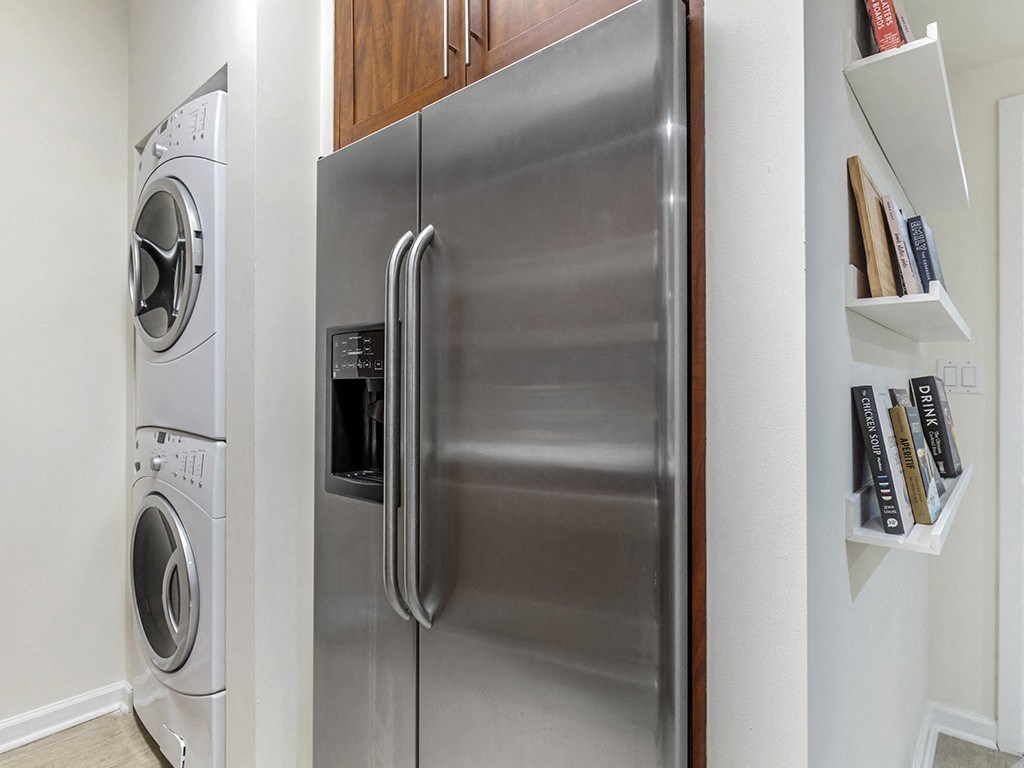 a stainless steel refrigerator and washer and dryer in a kitchen