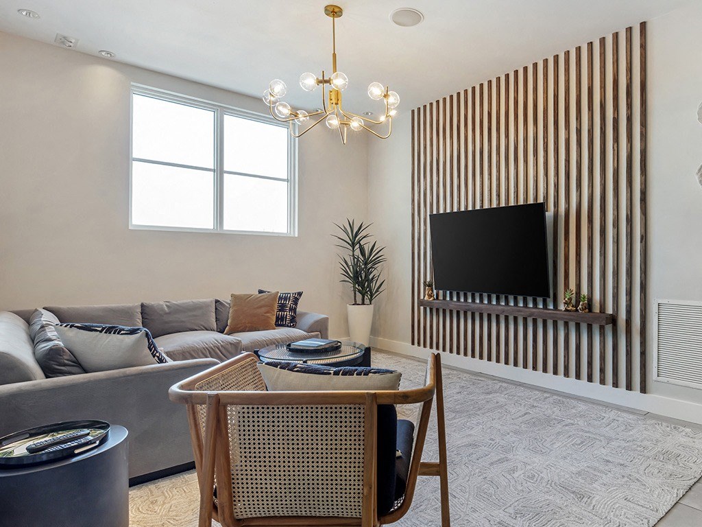 a living room with a couch and a table and a tv