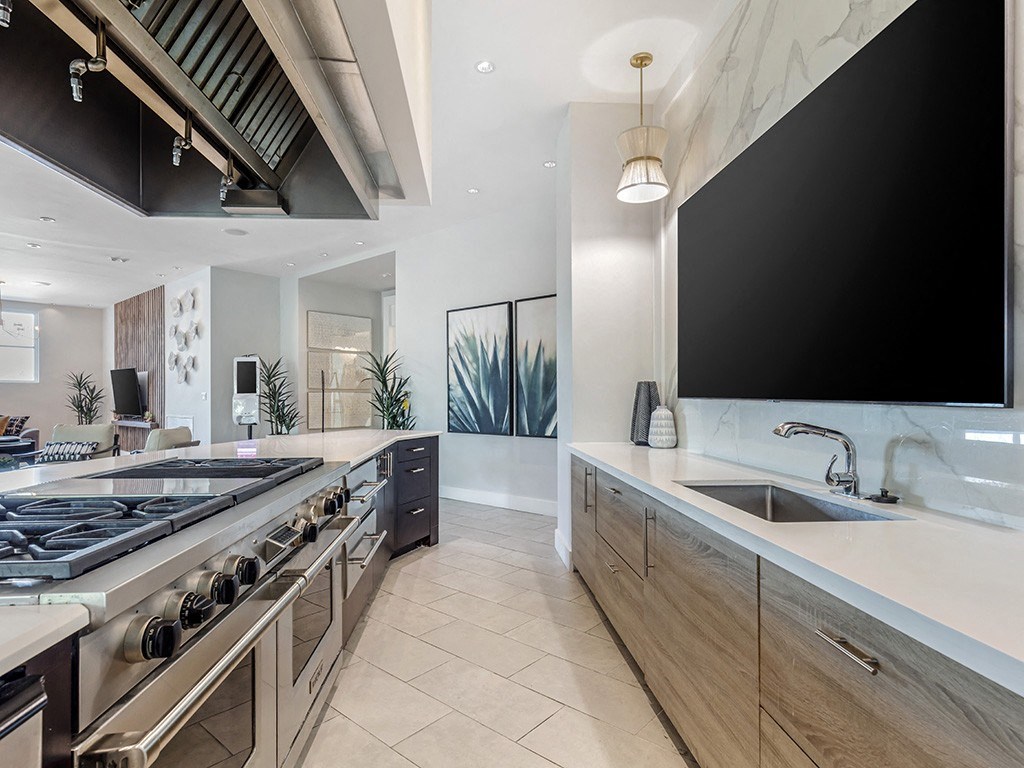 a kitchen with a stove and a tv