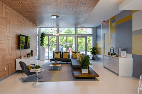 A modern living room with a white sofa and a black chair.