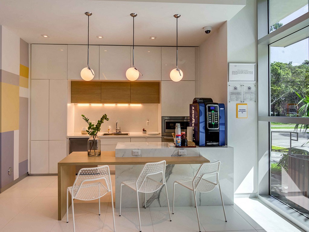 A modern kitchen with a table and chairs.