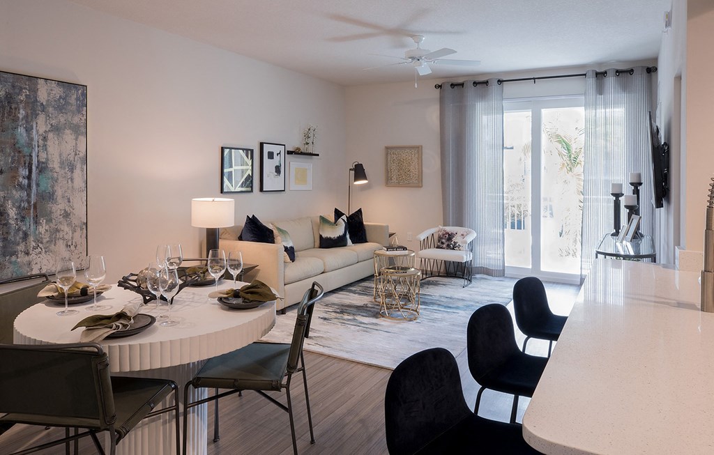 A modern dining room with a round table set for six.