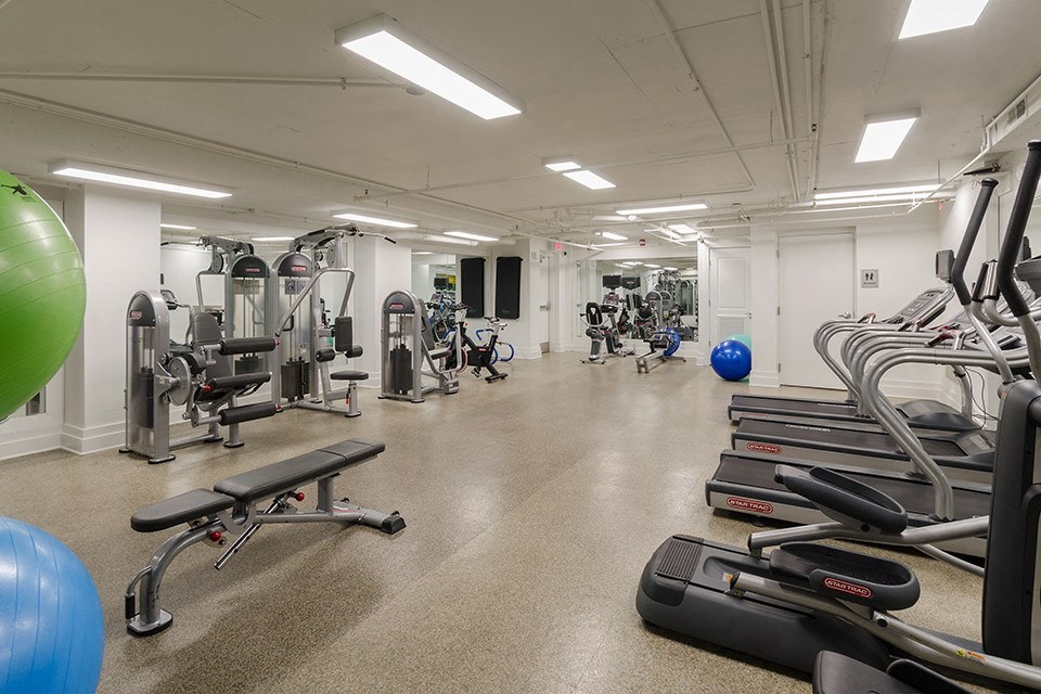 a gym with cardio equipment and weights in a building