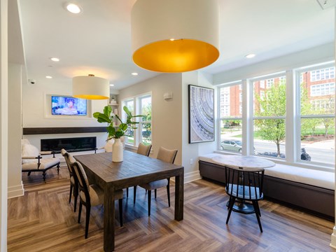 a dining room with a table and chairs and a large window