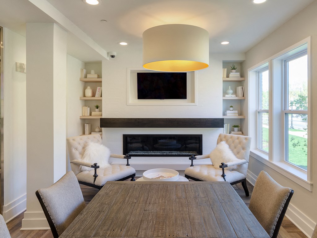 a dining room with a table and chairs in front of a fireplace