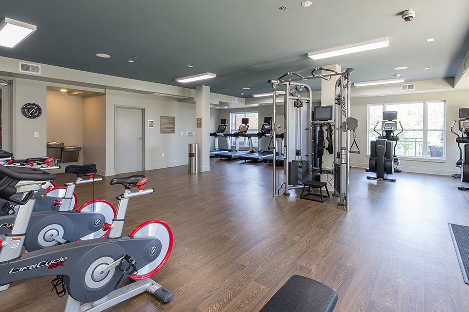 a gym with weights and cardio equipment in a building