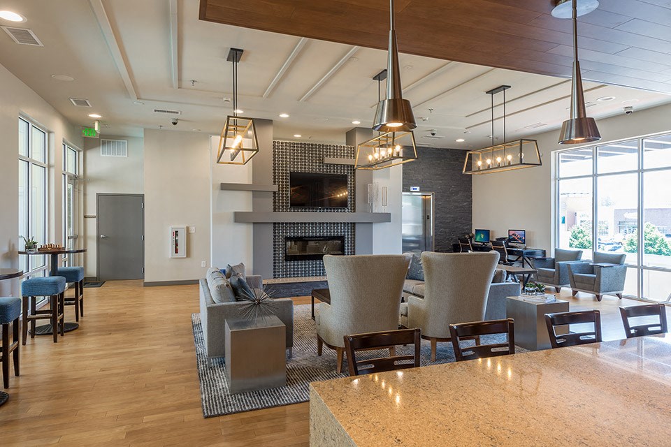a large living room with furniture and a fireplace