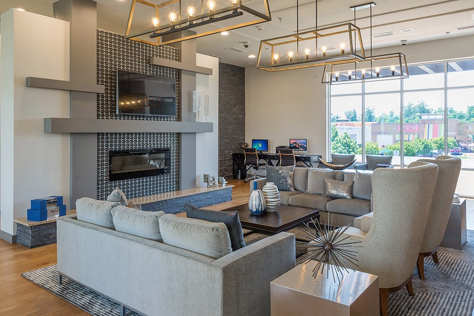 a living room with couches and chairs and a fireplace