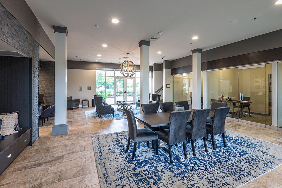 a dining room and living room with a table and chairs
